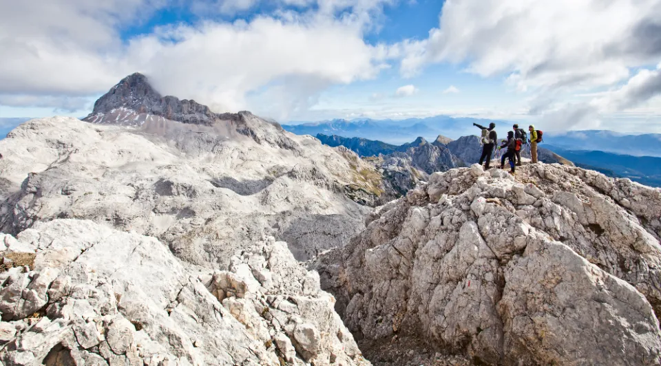 Hikers on a mountain ridge in the Julian Alps