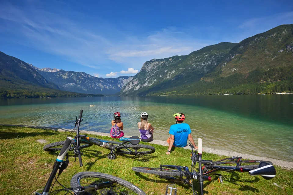 Cyclists resting by a mountain lake
